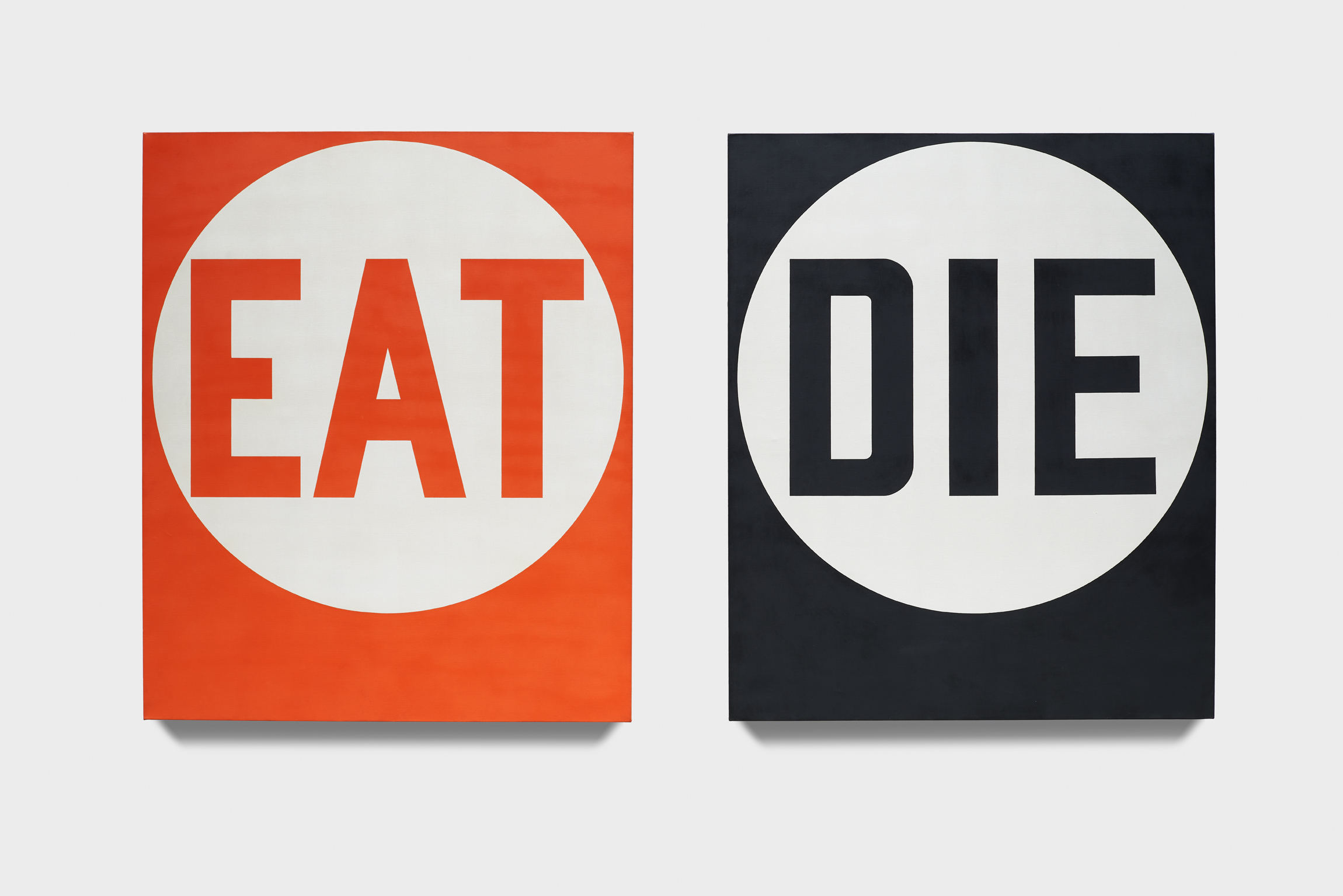 Two painted panels, one red with the word EAT in a white circle, the other black with DIE in a white circle.