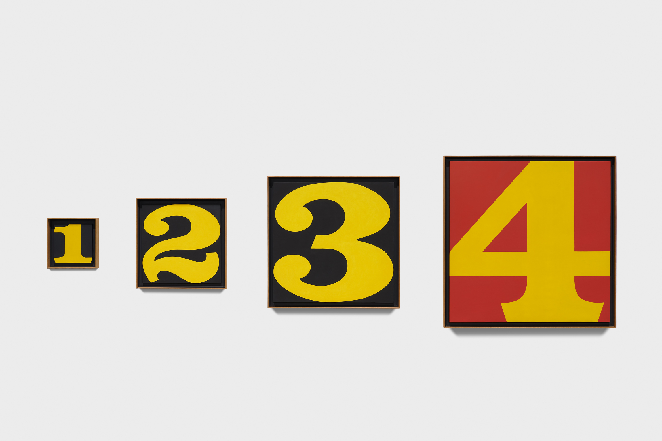 Four painted panels with the numbers 1–4 getting larger the higher the number.
