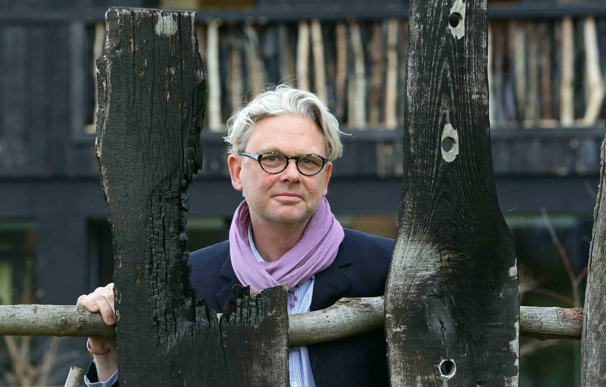 A man with grey hair and glasses.