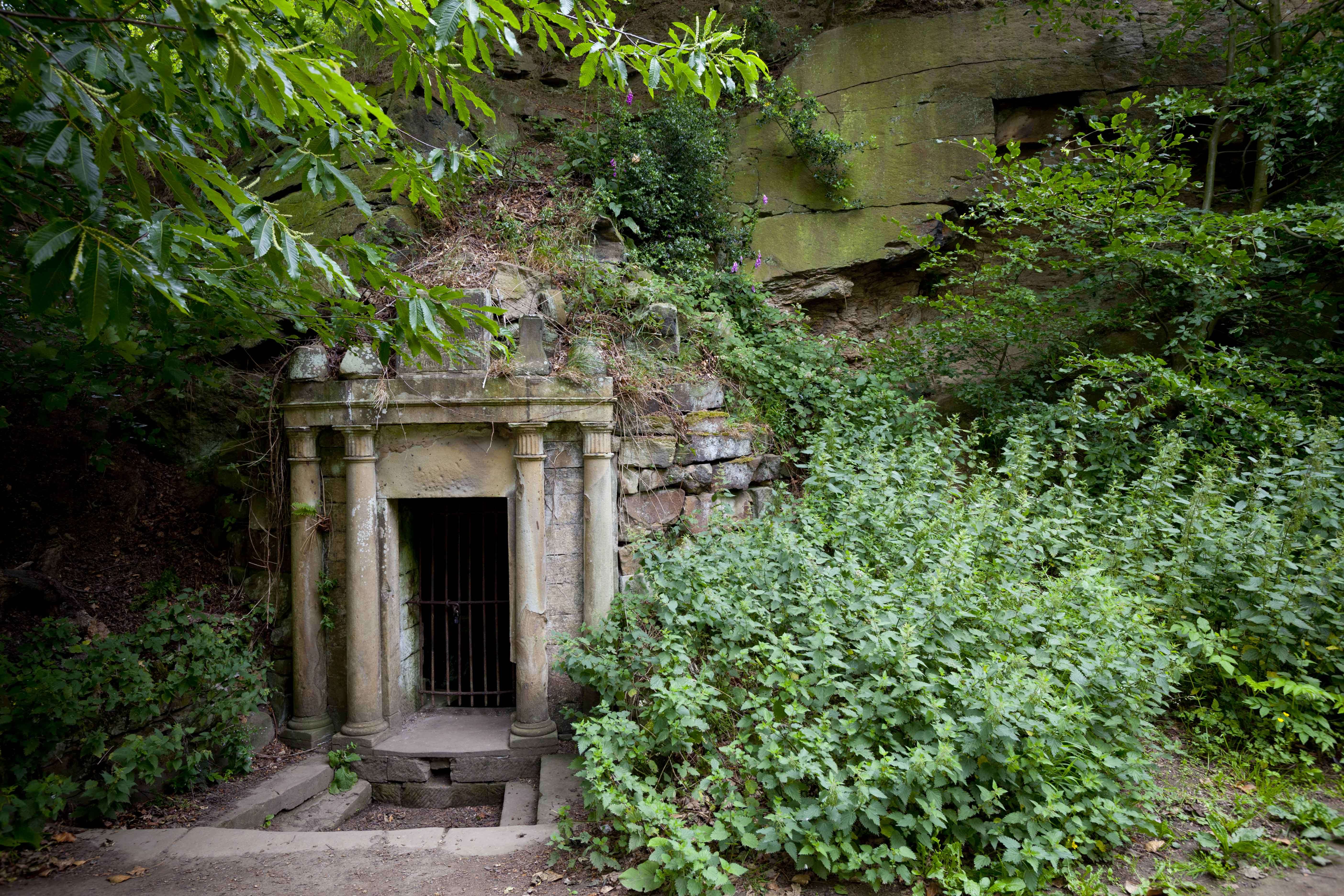 Lady Eglinton's Well embedded into rocks surrounded by greenery.