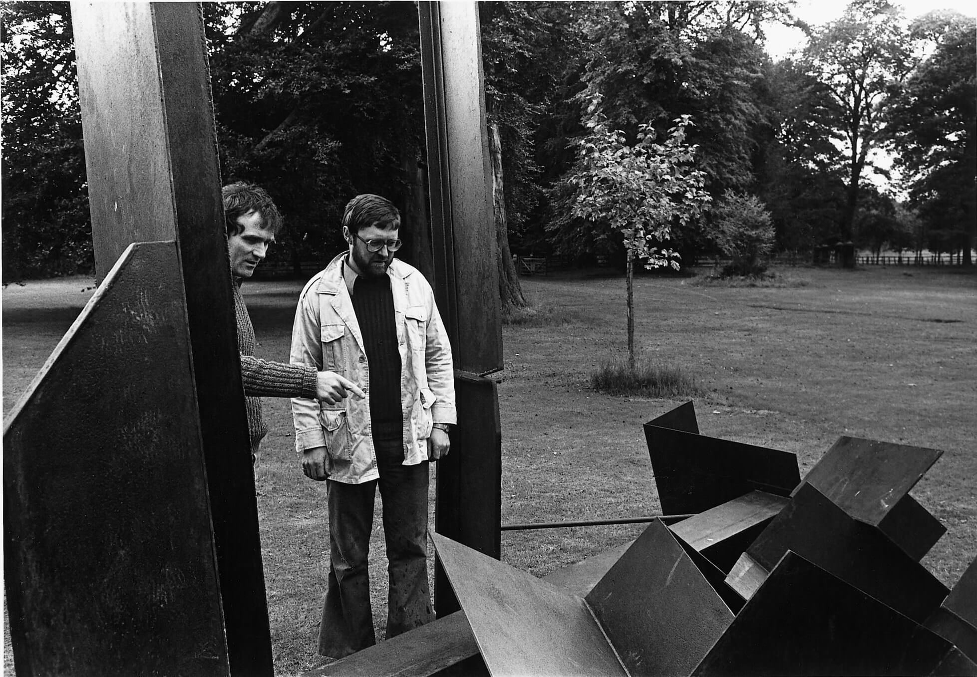 Two men looking at a sculpture, Founder of YSP Peter Murray CBE with artist Michael Lyons.