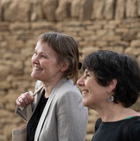 Two women smiling inside Peter's Fold.