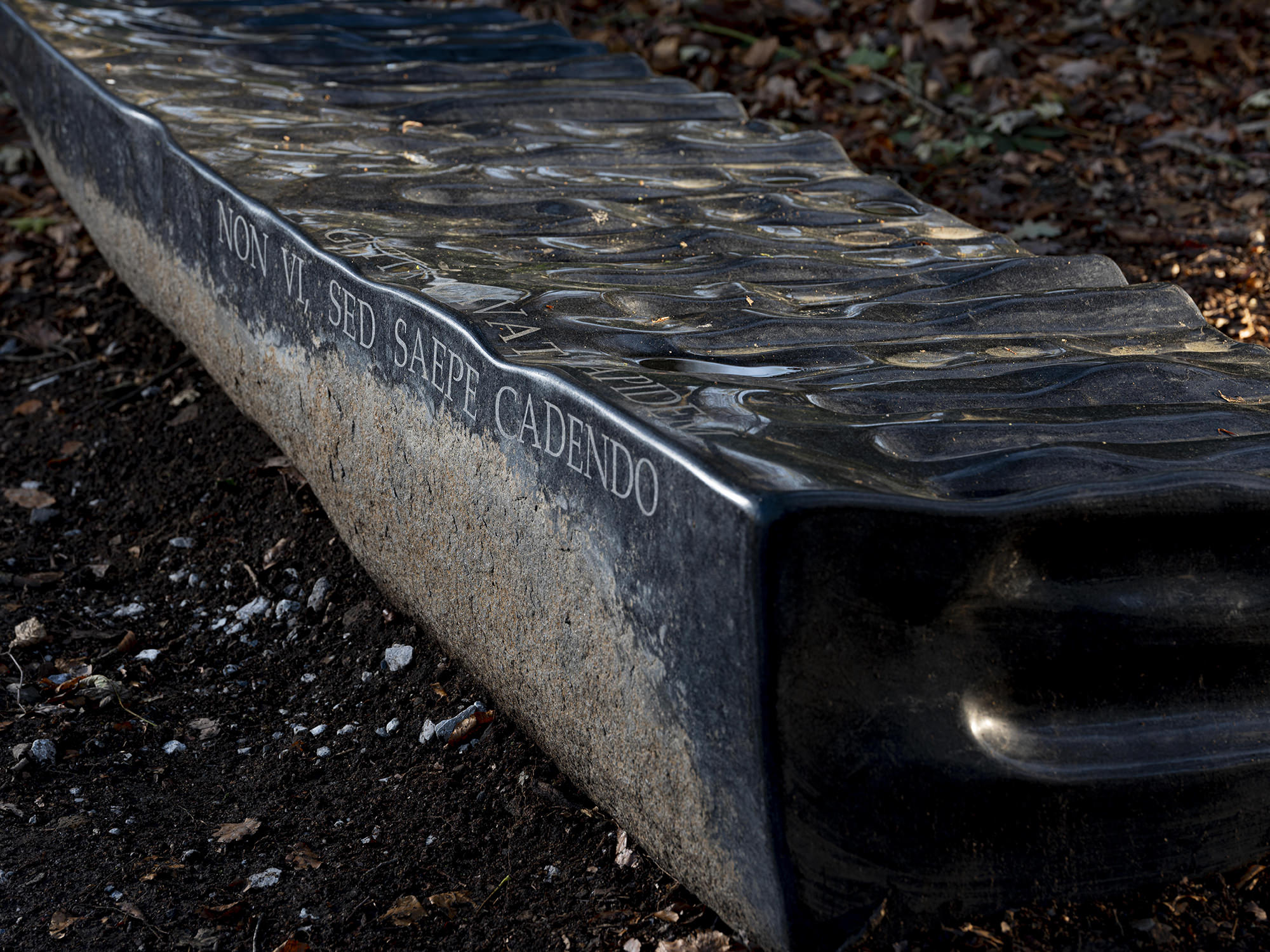 Detail of Willem Boshoff – Flagstone 2016 which reads "Gutta cavat Lapidem,"at Yorkshire Sculpture Park