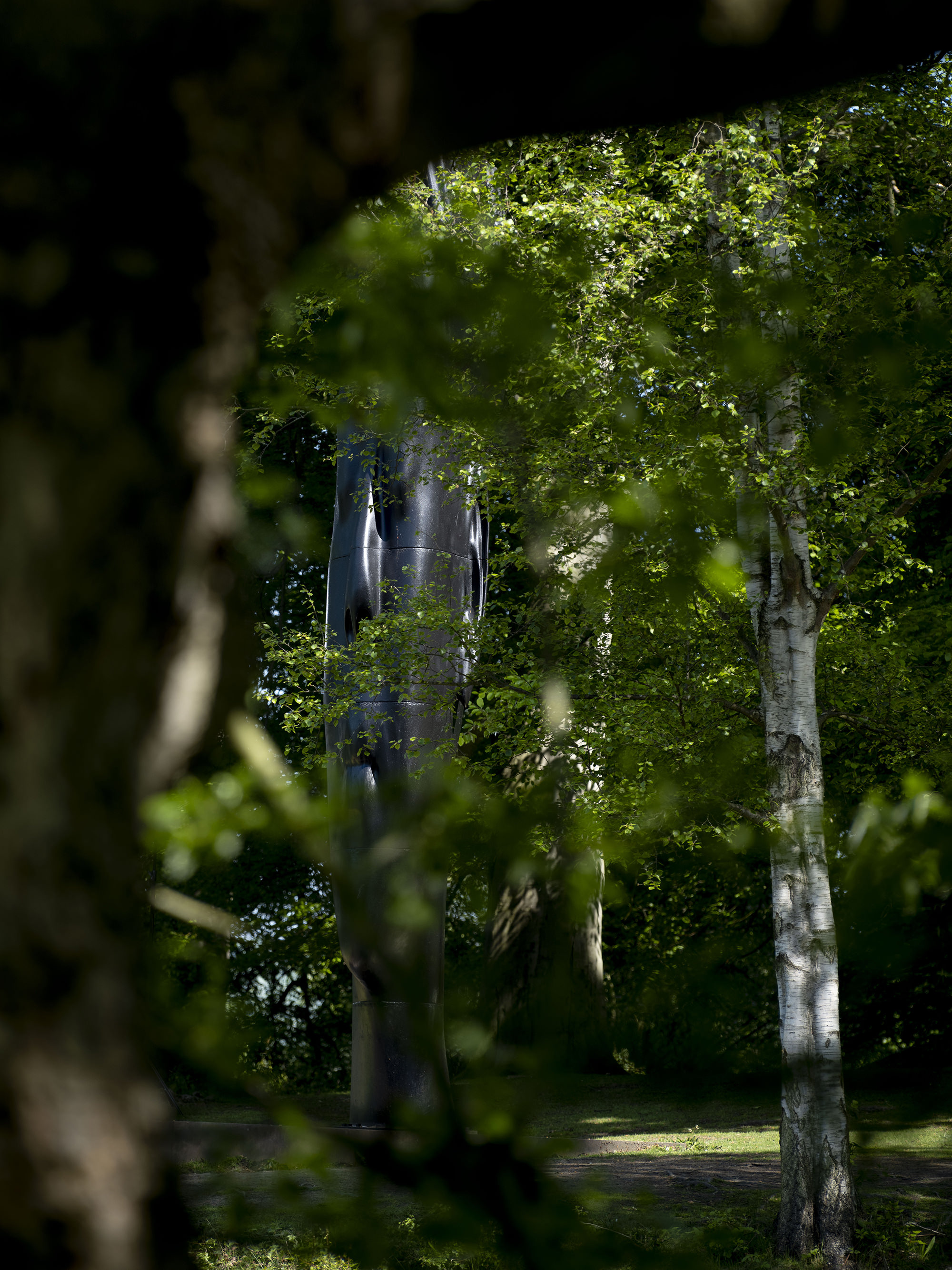Jaume Plensa, Wilsis seen through the trees at Yorkshire Sculpture Park