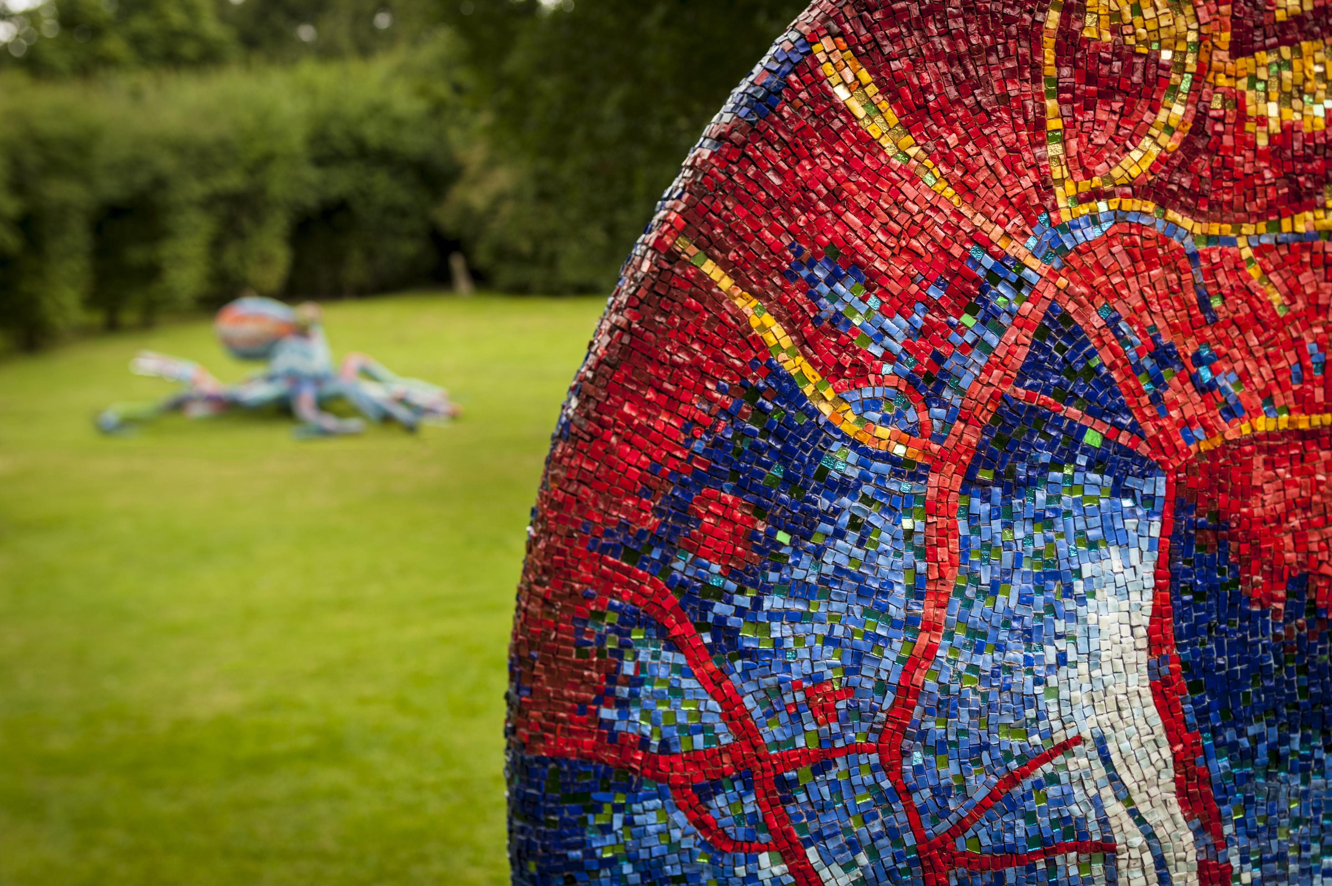 A close up of a red and blue mosaic sculpture