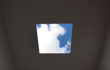 The view through a square hole in the roof of Skyspace, showing a blue sky with clouds.