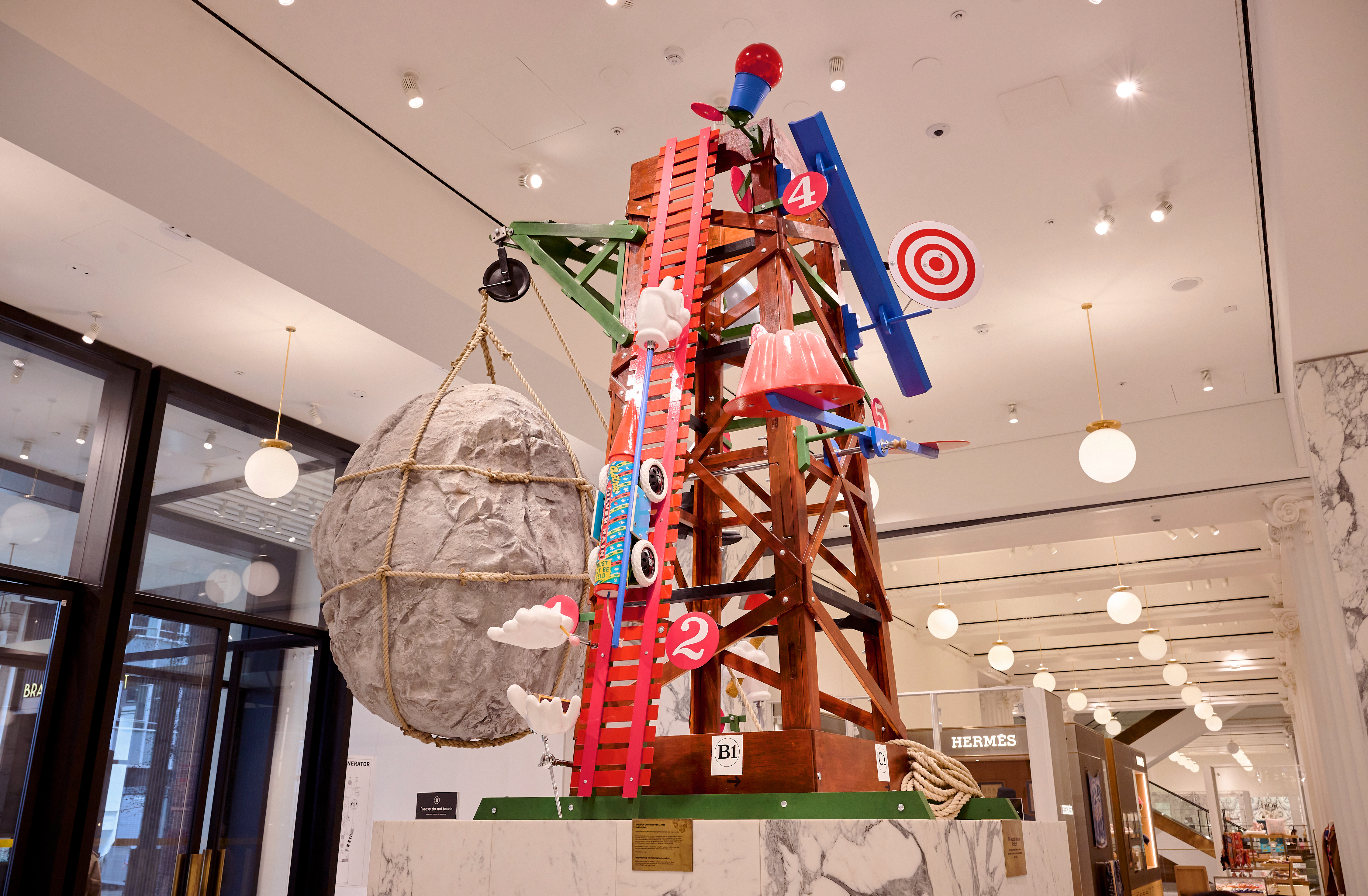 A colourful scaffolding structure with giant targets, models of cars, targets and giant rocks.