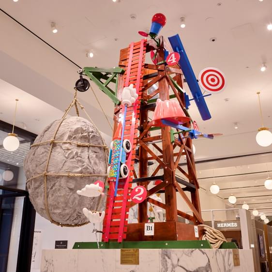 A colourful scaffolding structure with giant targets, models of cars, targets and giant rocks.