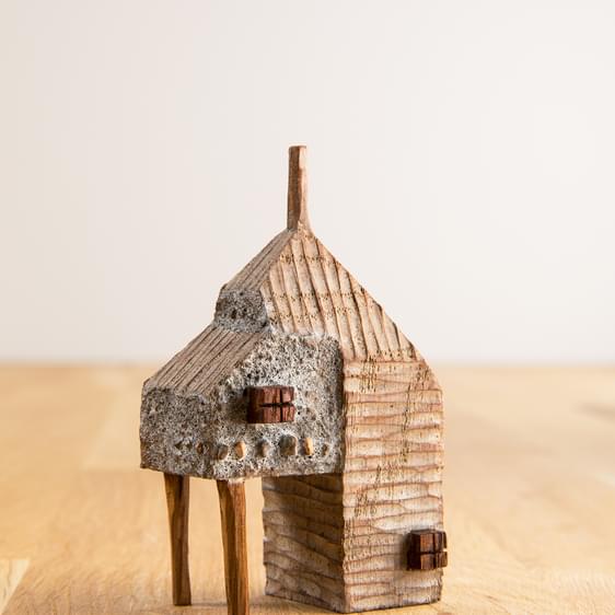 A miniature carved wooden house