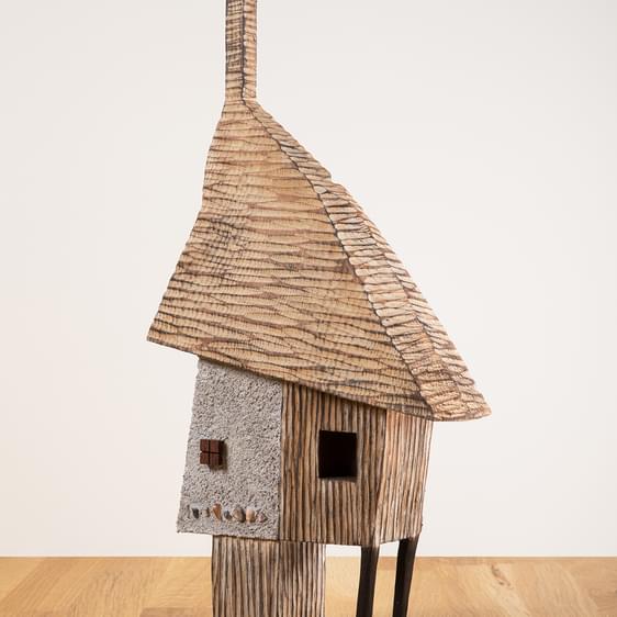 A miniature carved wooden house