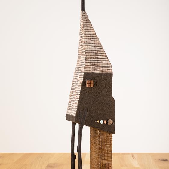 A miniature carved wooden house