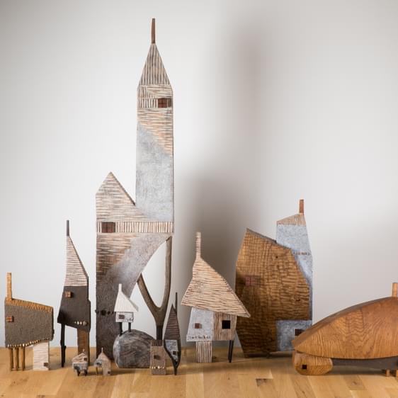 A group of carved wooden houses