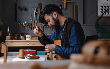 A bearded man, working in a studio