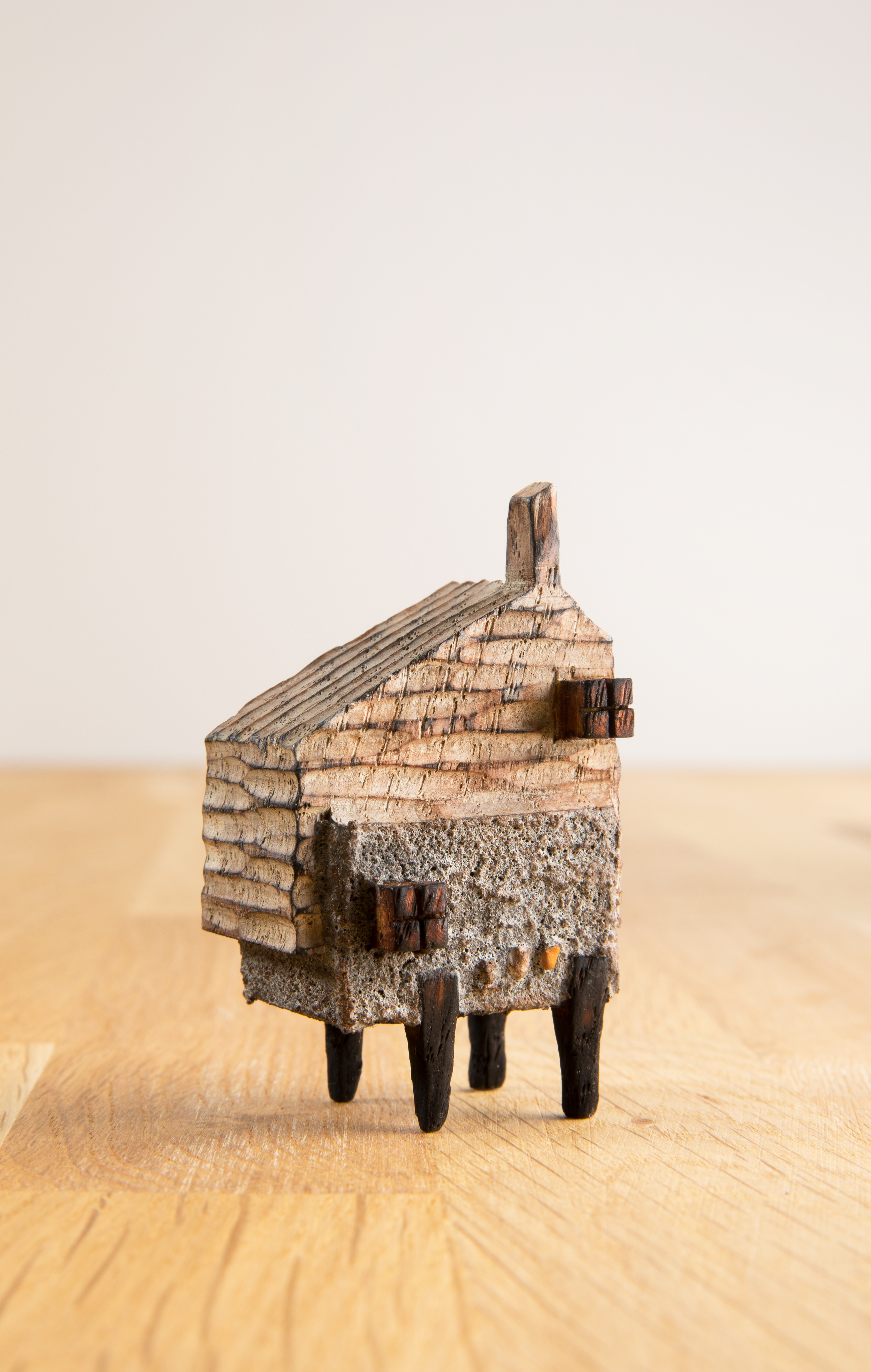A miniature carved wooden house