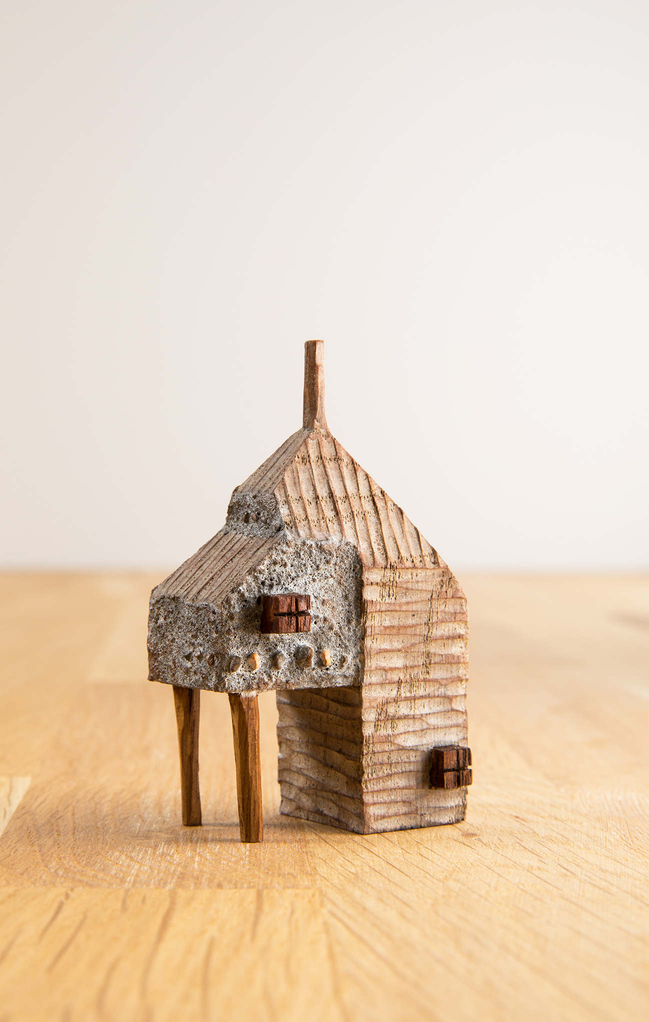 A miniature carved wooden house