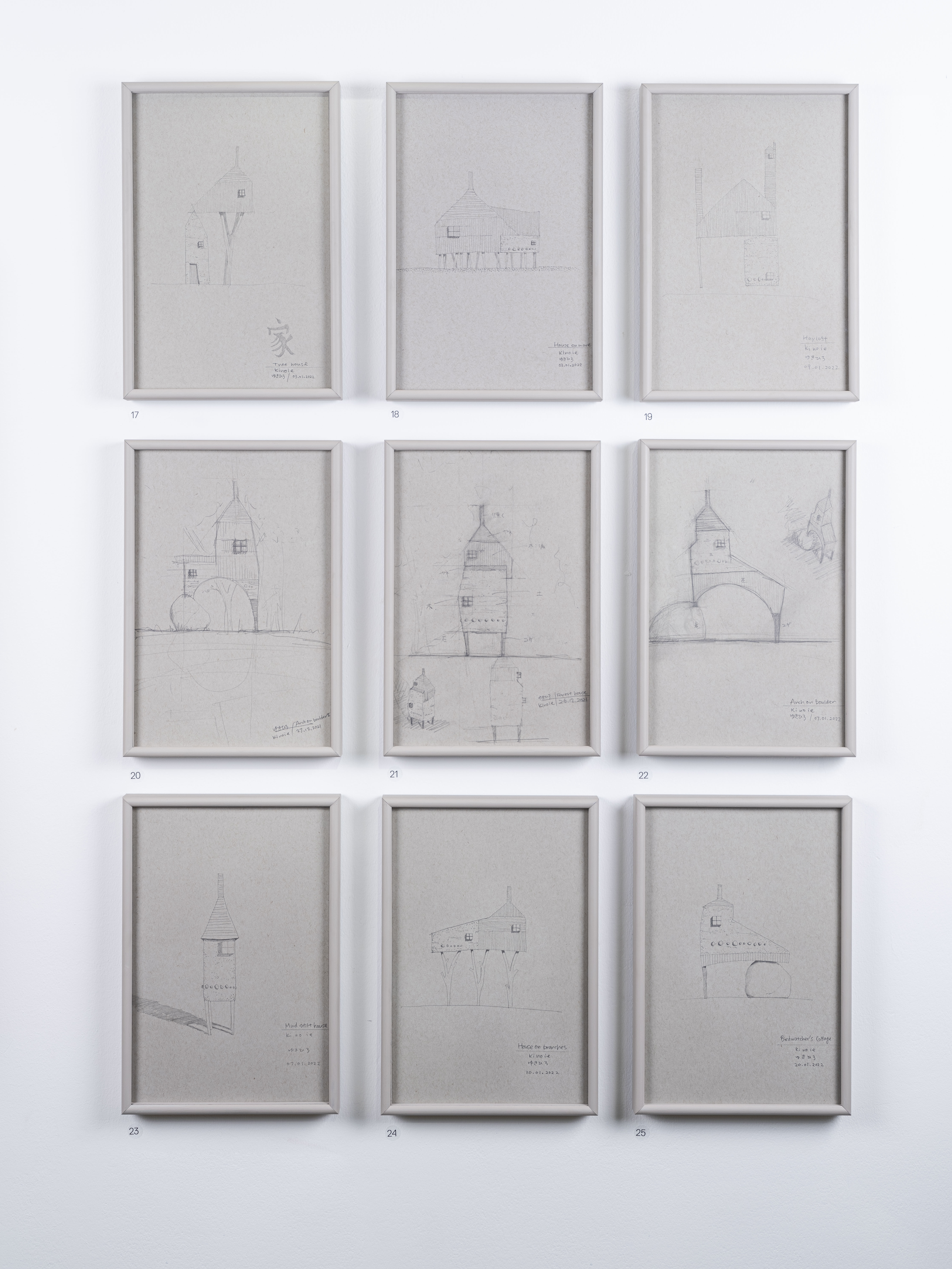 Nine framed pencil drawings of miniature houses.