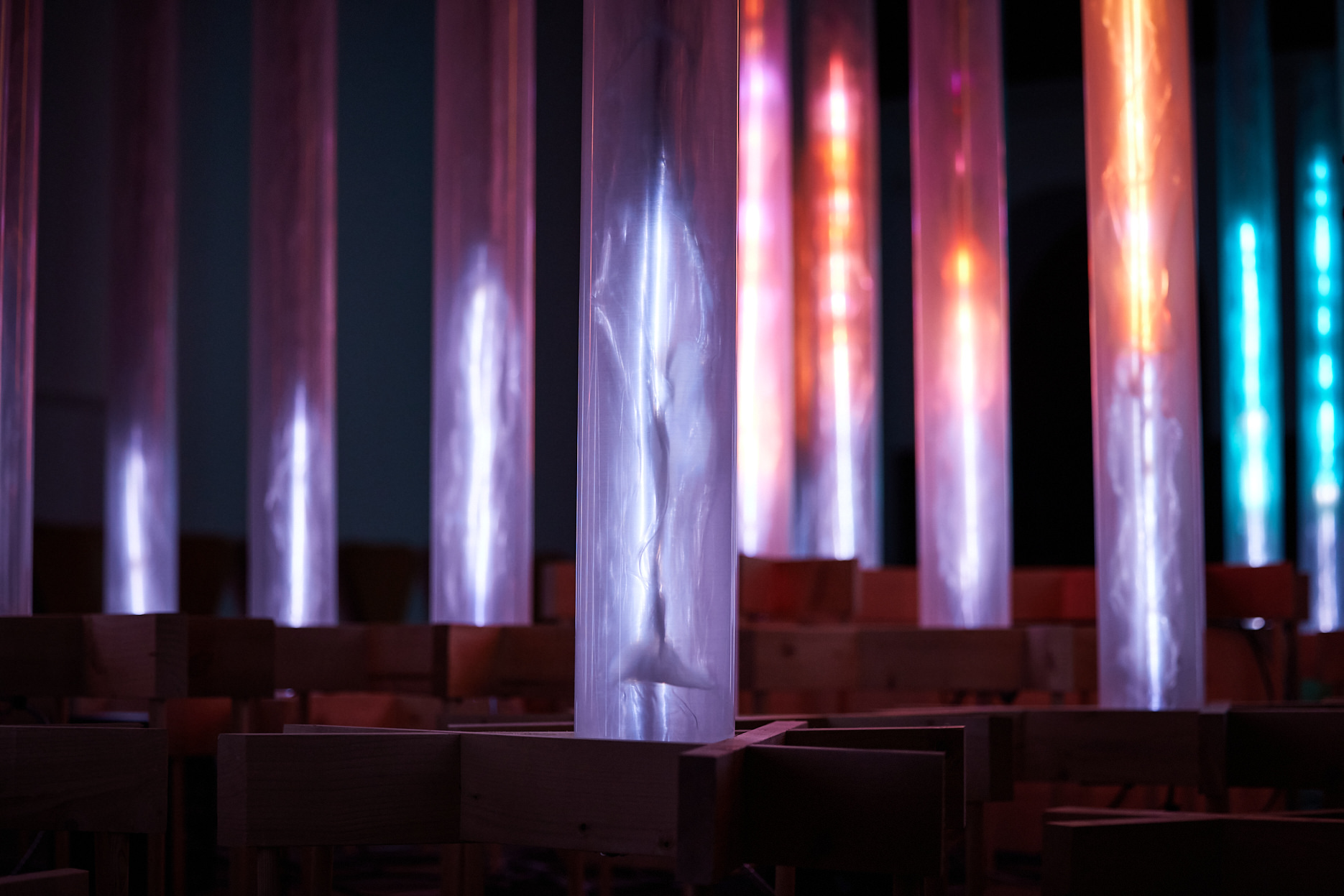 An installation of pink and blue glowing columns.