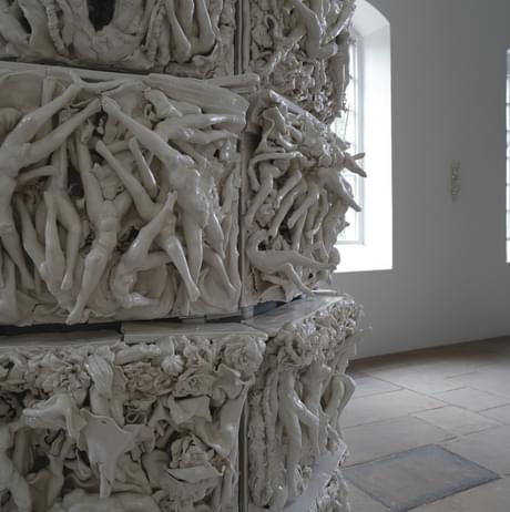 Multiple porcelain tiles of legs and torsos intertwined.