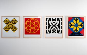 Four paintings hung in a row on the wall.