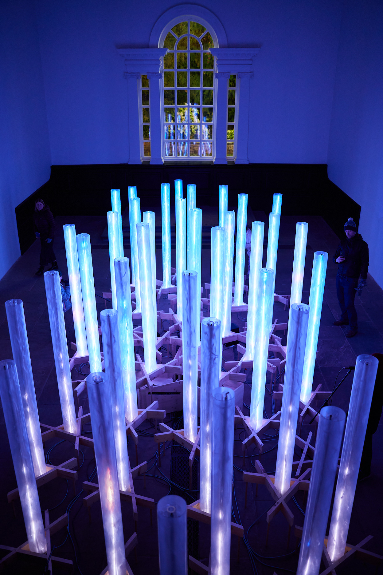 An aerial view of a series of blue glowing columns inside the Chapel