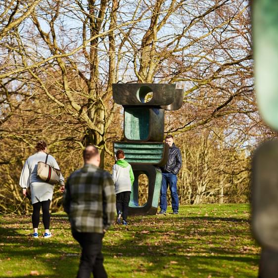 People looking at Barbara Hepworth's Family of Man.