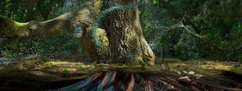 A majestic tree stands in a lush forest, its thick trunk and sprawling roots visible. Delicate particles of light shimmer around the tree, creating a magical atmosphere. The vibrant greenery and intricate root system highlight the beauty of nature.