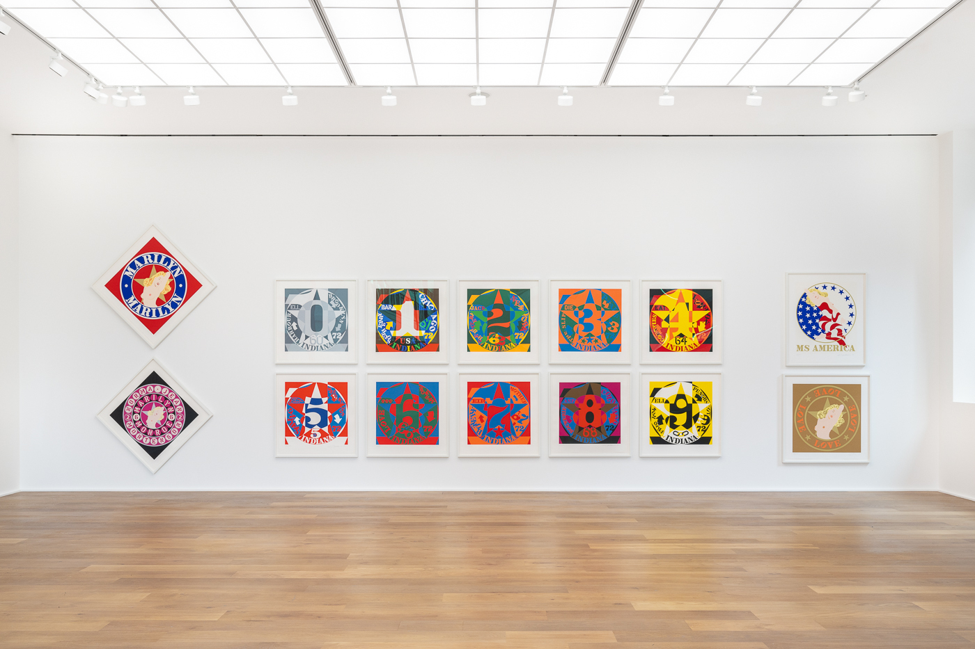 A display of brightly coloured pop art prints in a gallery.