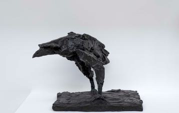 A bronze sculpture of a raven