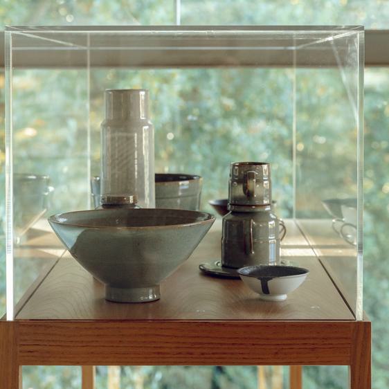 Cabinet of ceramic vessels including bowls and vases