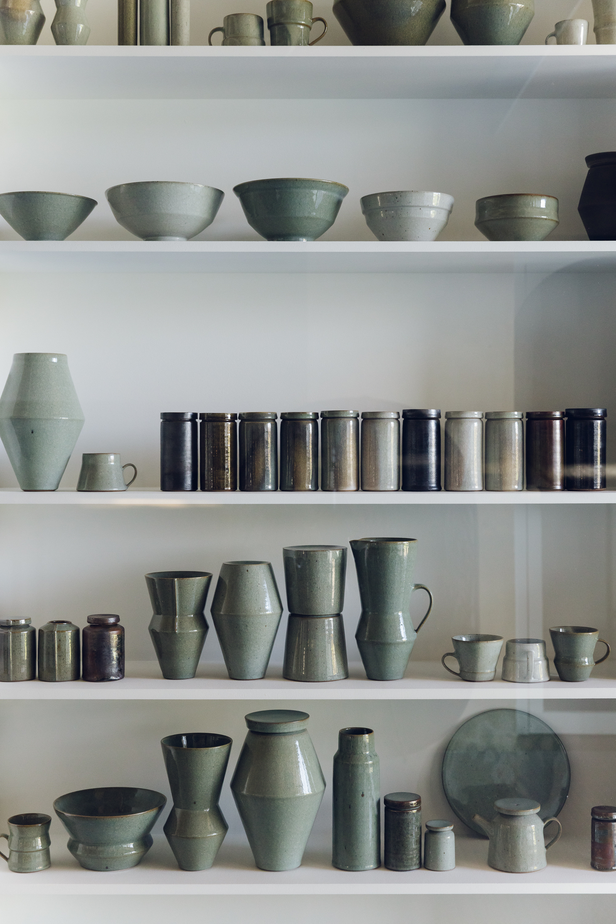 Ceramic vessels on shelves
