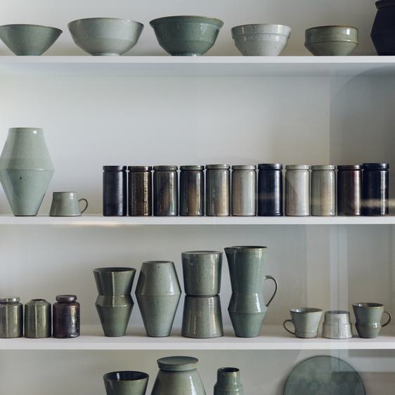 Ceramic vessels on shelves