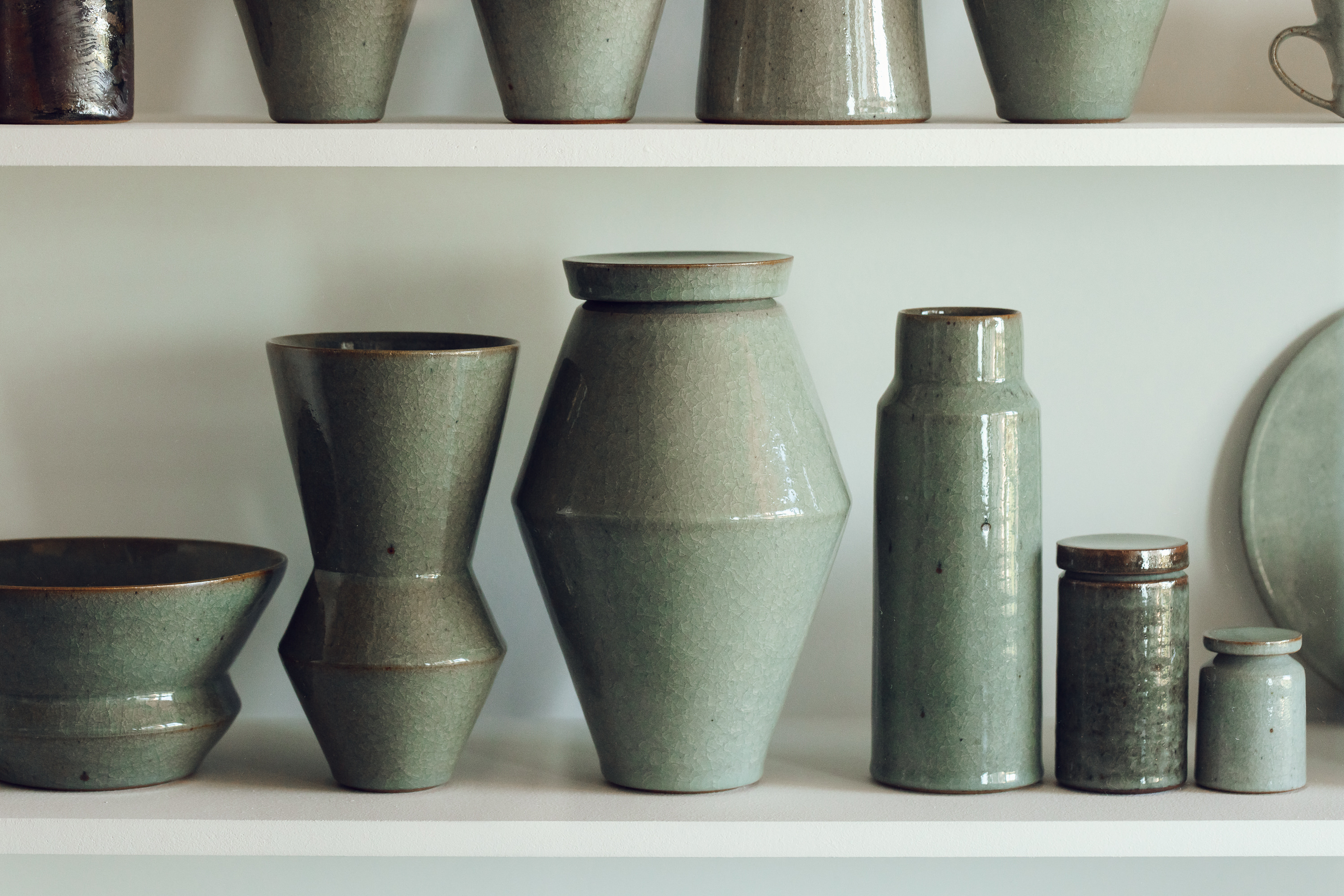 A selection of ceramic vessels on a shelf