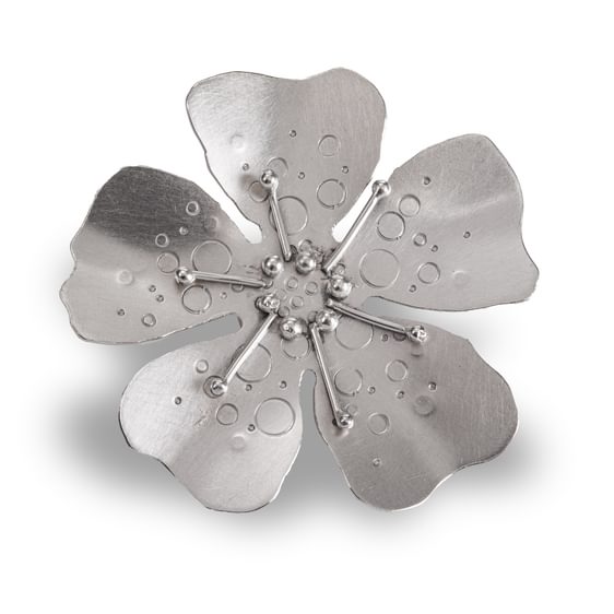 A silver flower broach.
