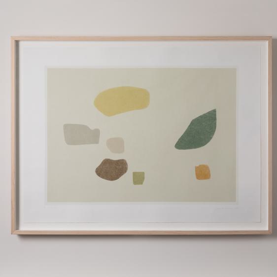 A framed print hung a wall.