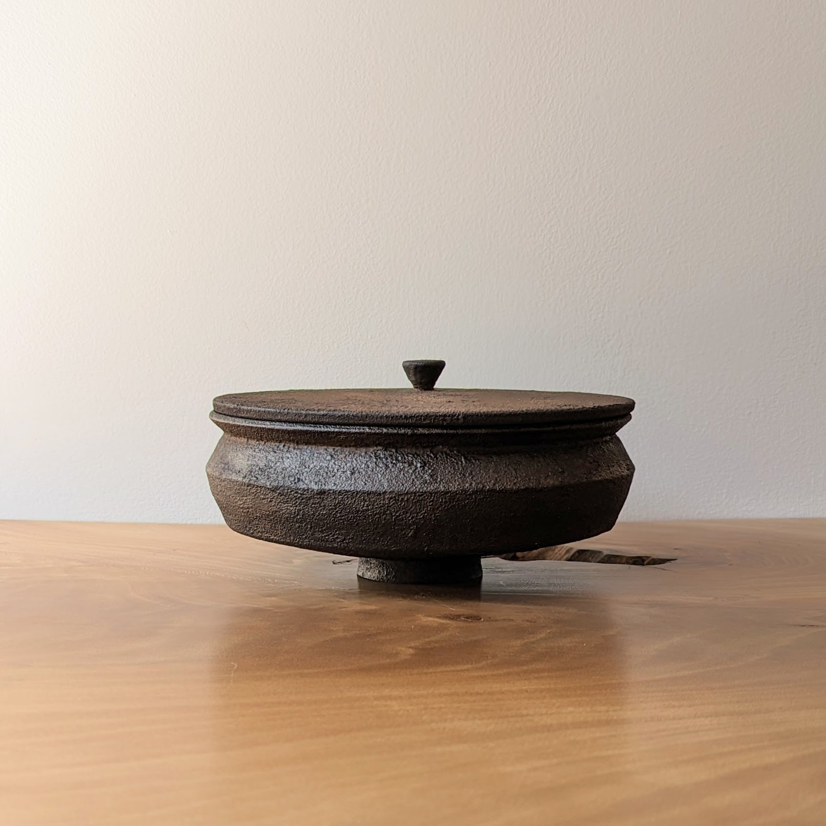 Dark wooden vessel with lid
