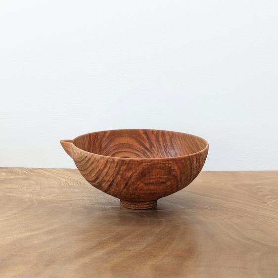 Small wooden vessel with a pouring spout