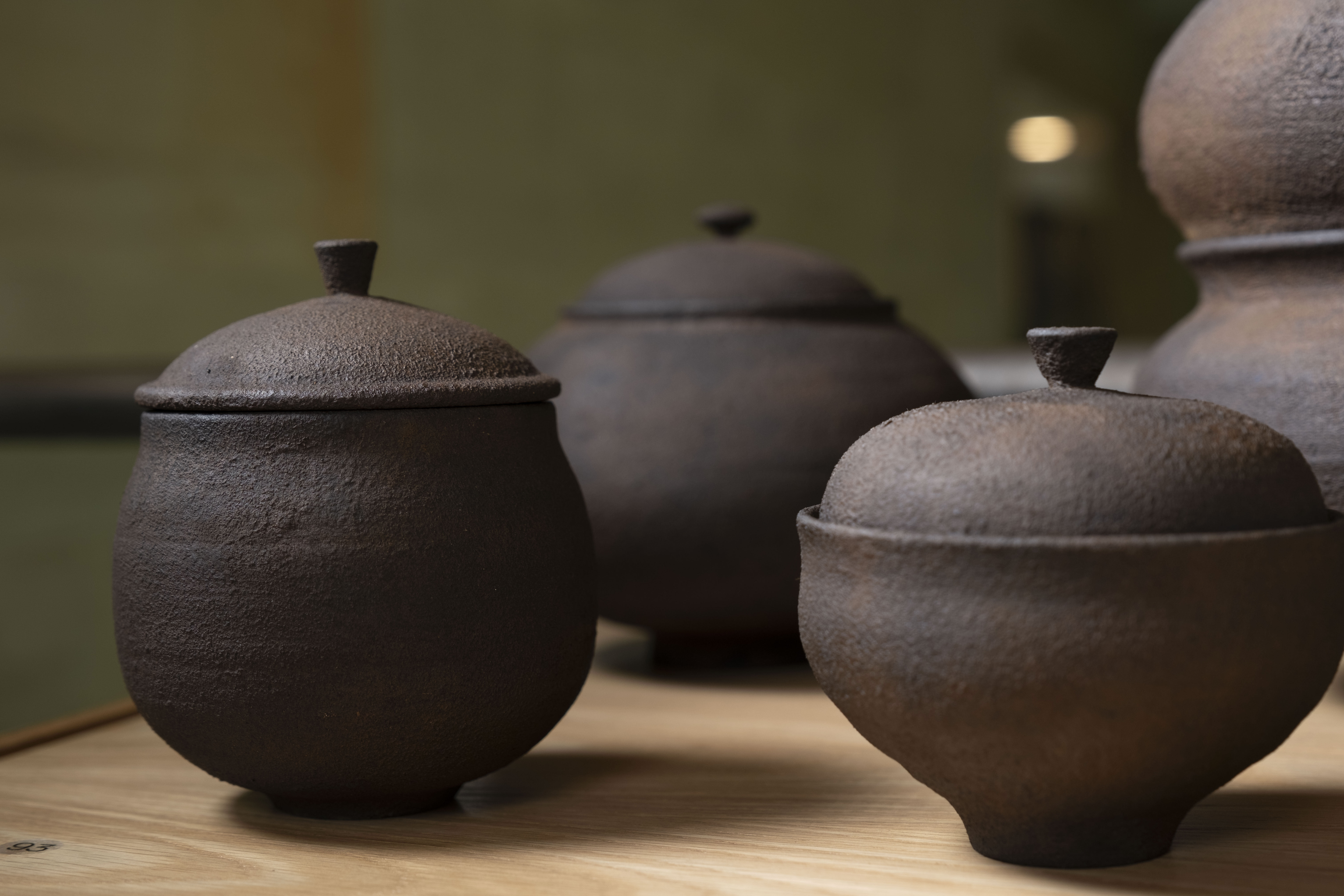 Dark wooden vessels with lids
