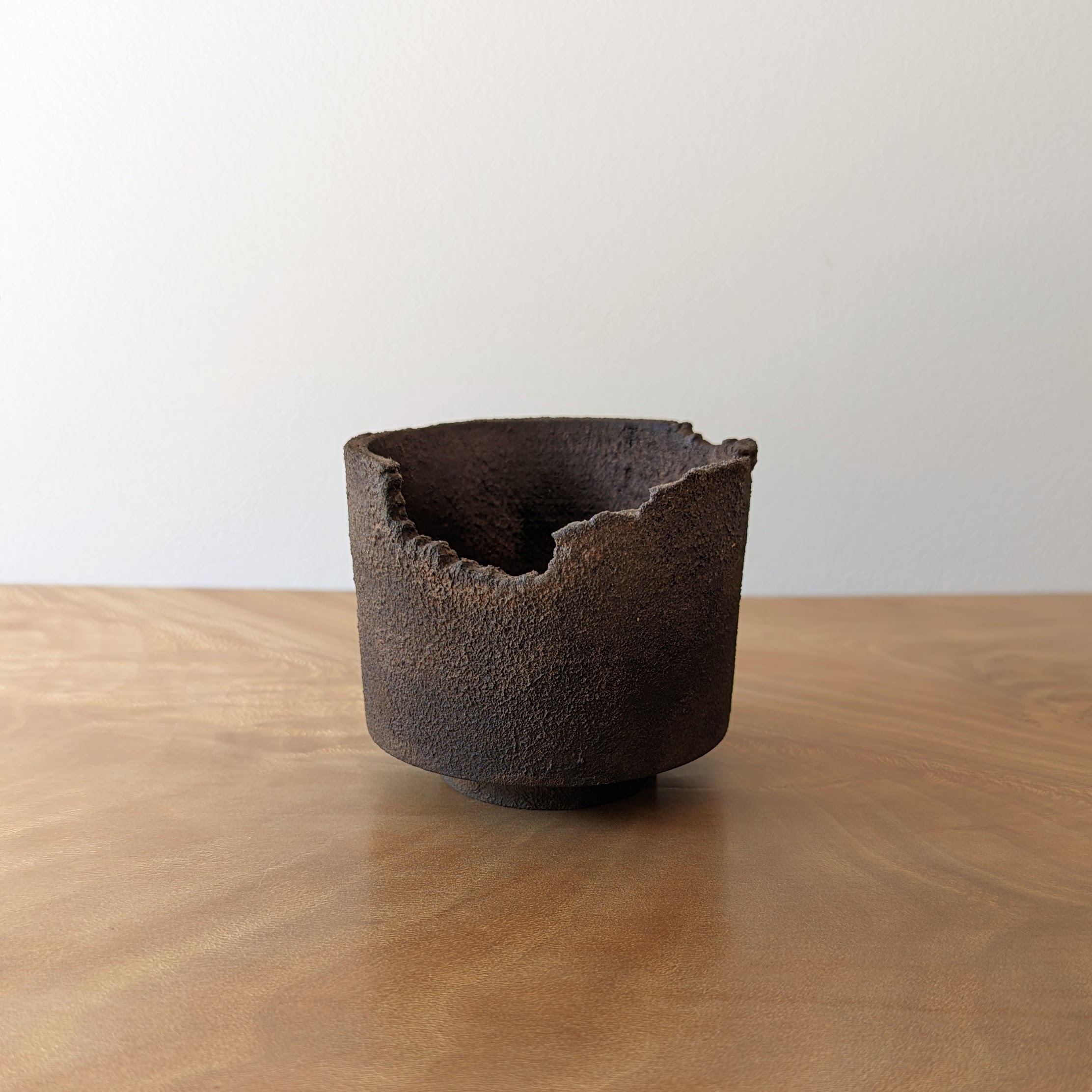 Small dark wooden vessel