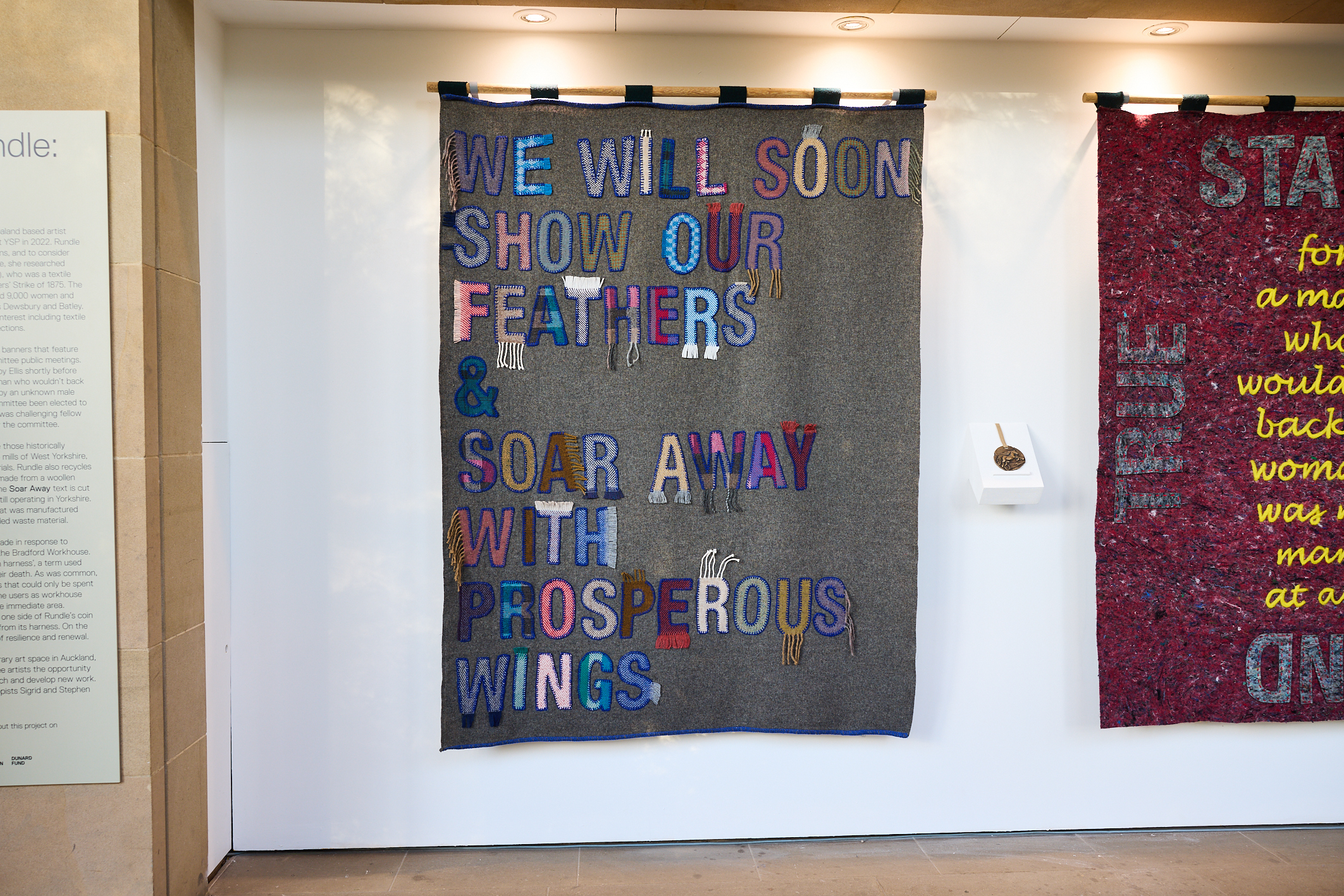 A display of fabric banners with appliquéd lettering
