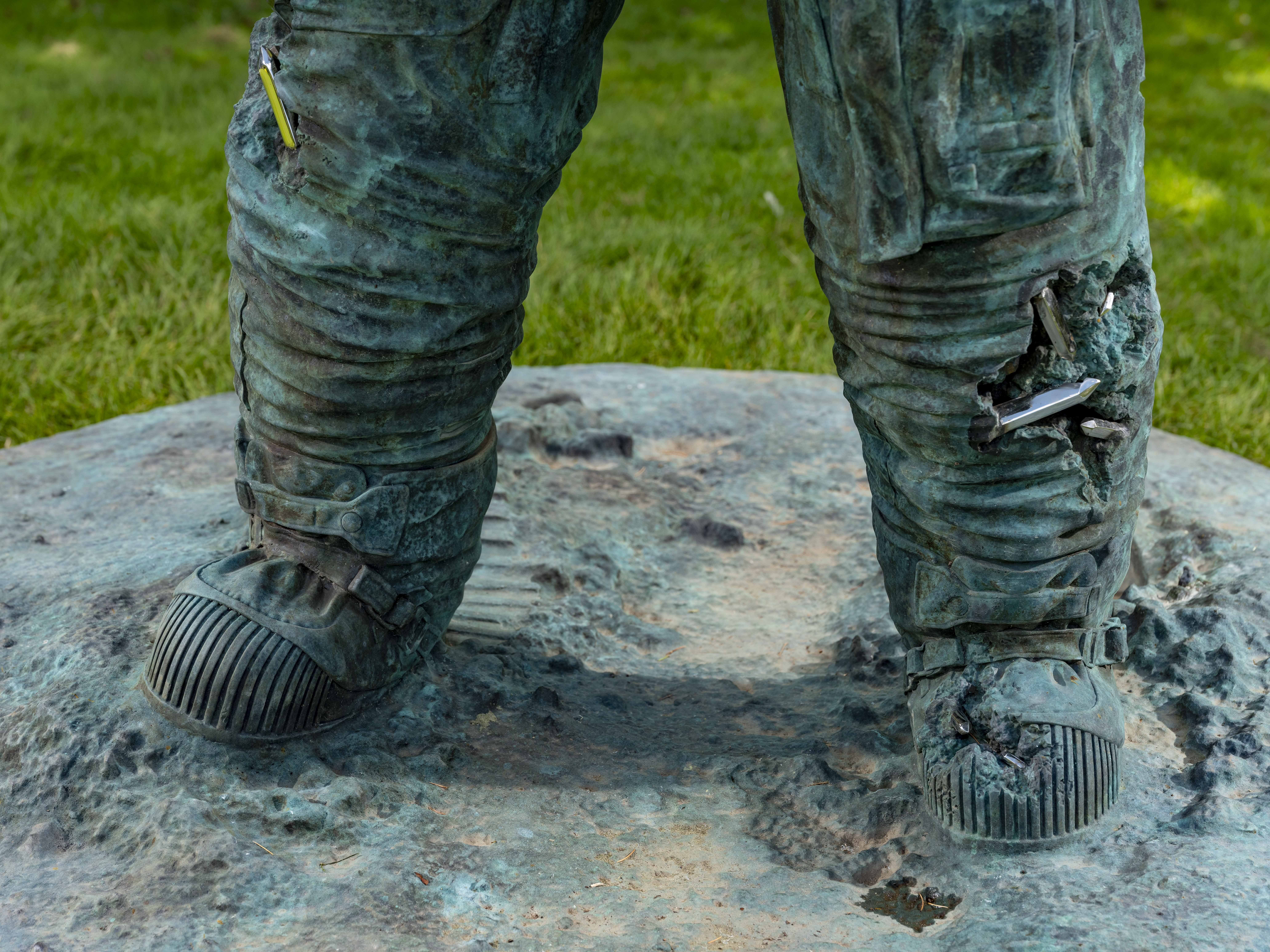 A close up of the legs of an astronaut sculpture
