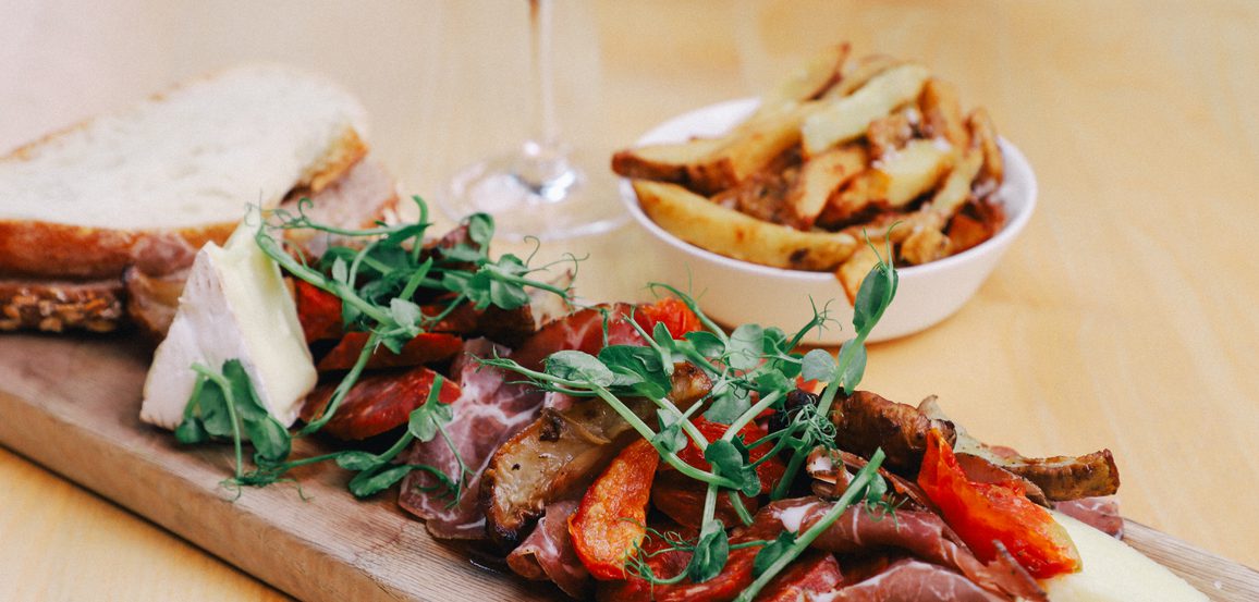 A board of cheese and charcuterie meats.