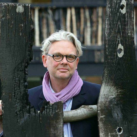 A man with grey hair and glasses.