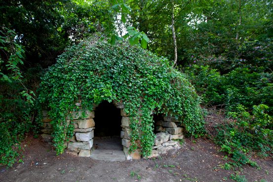 Shell Grotto covered in green ivy.