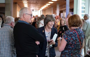 A group of people talking in the YSP Visitor Centre