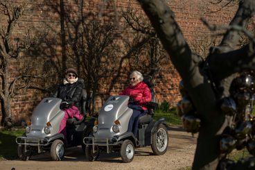 A pair of visitors using tramper mobility scooters.