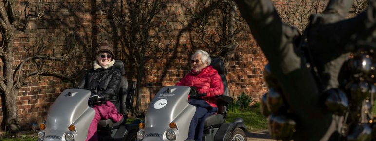A pair of visitors using tramper mobility scooters.