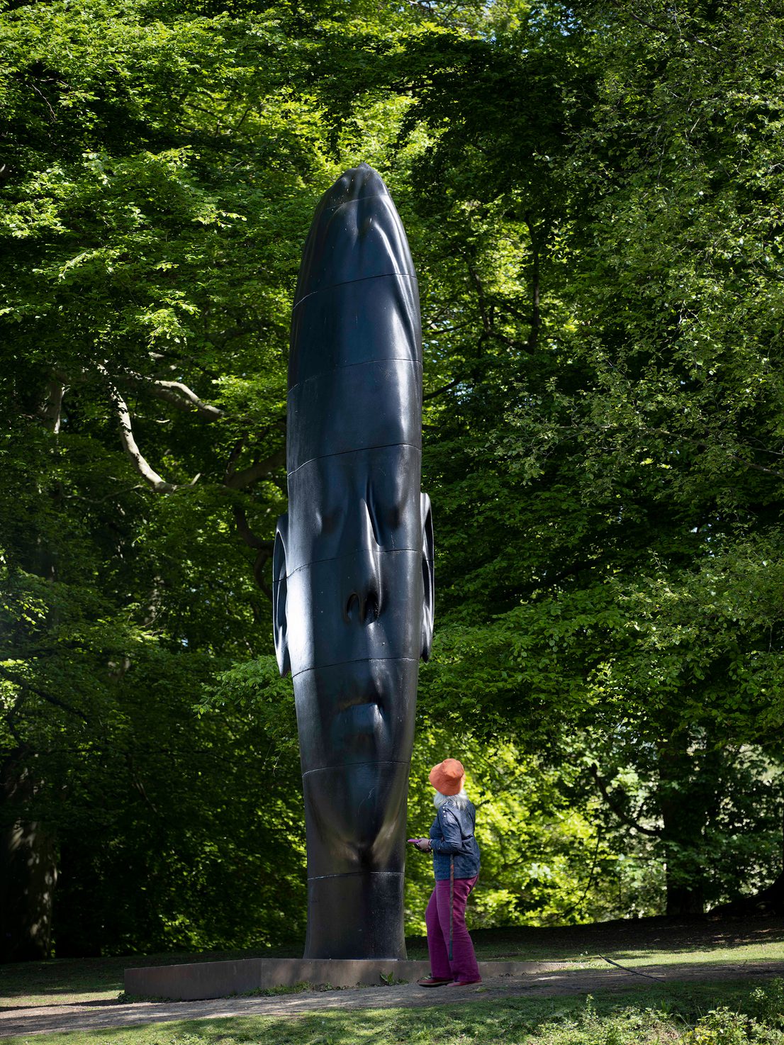 A white woman looking up at Jaume Plensa, Wilsis at Yorkshire Sculpture Park
