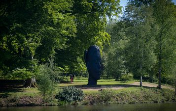 Jaume Plensa, Wilsis seen from across a lake at Yorkshire Sculpture Park