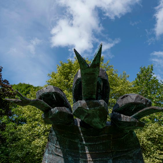 A close up of a three headed snake sculpture