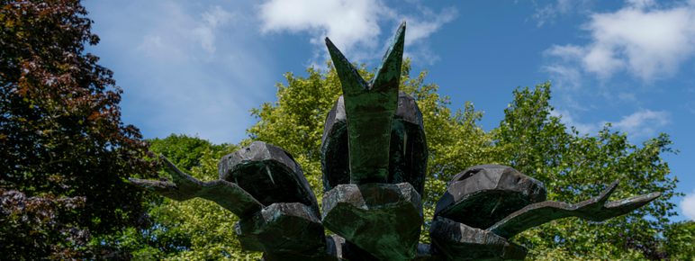 A close up of a three headed snake sculpture